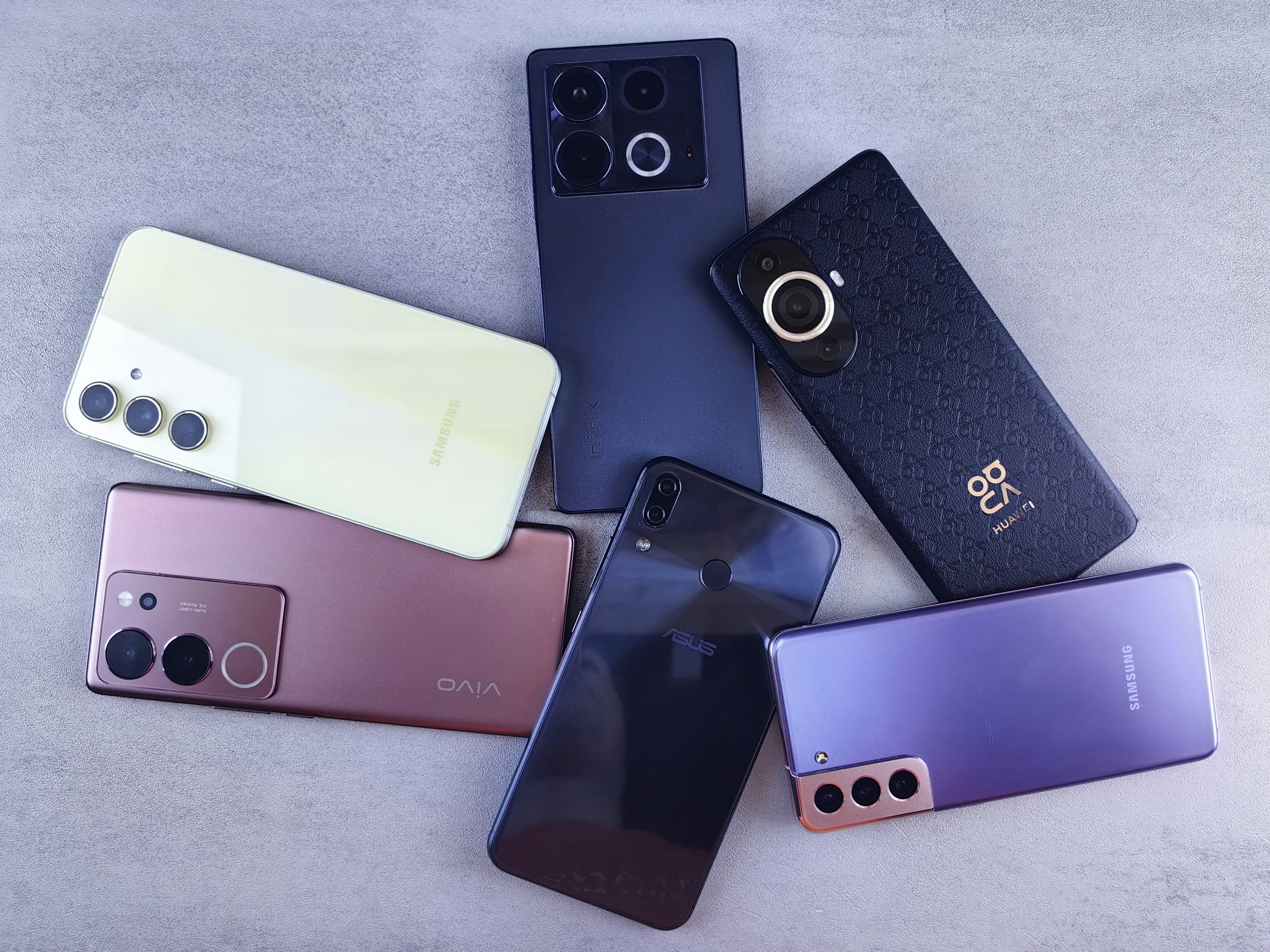 Several smartphones laid out on a desk
