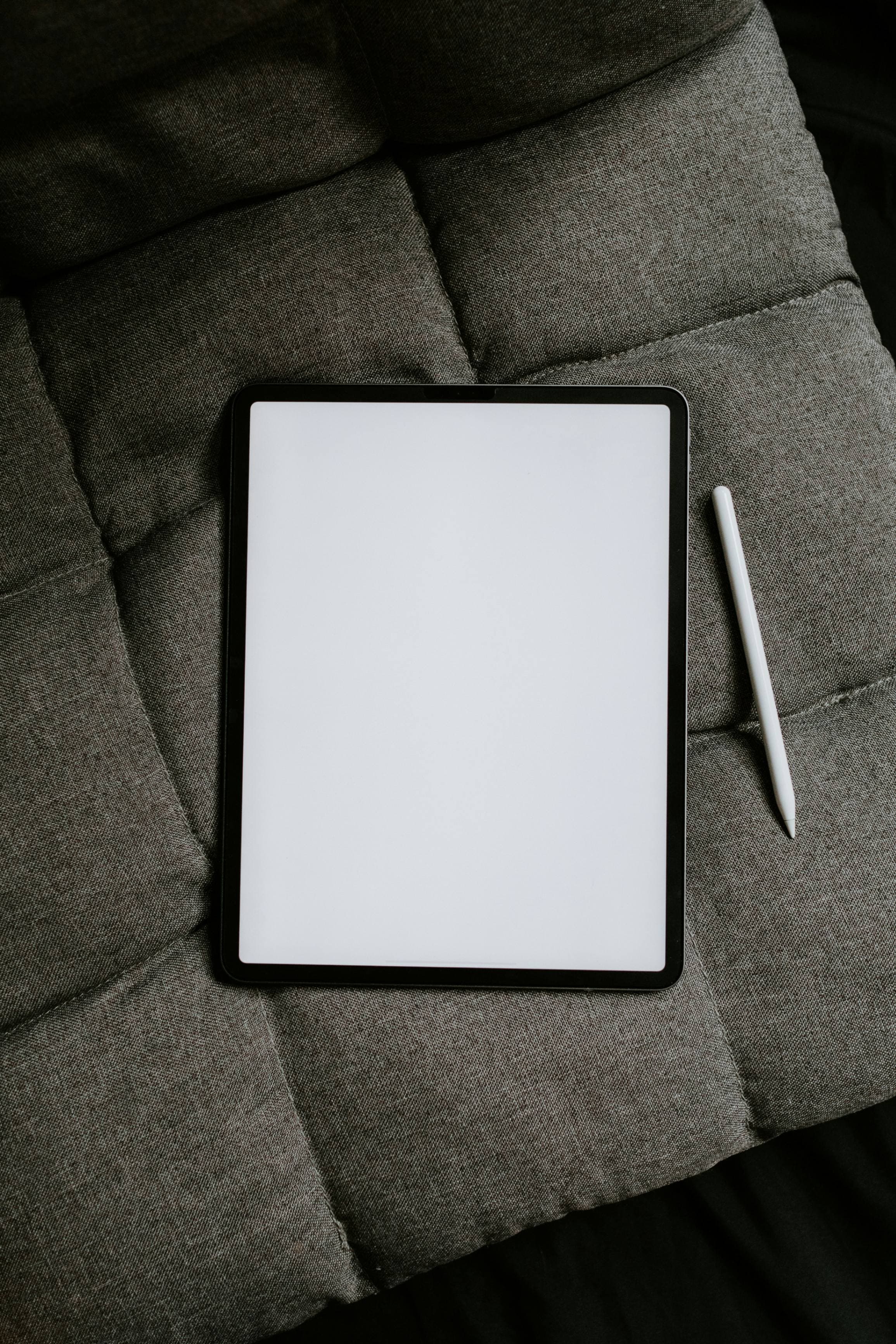A tablet with a stylus resting on top
